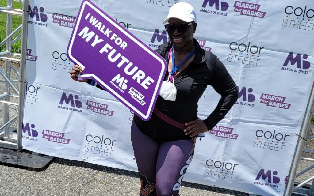 Woman holding a sign that says I walk for my future